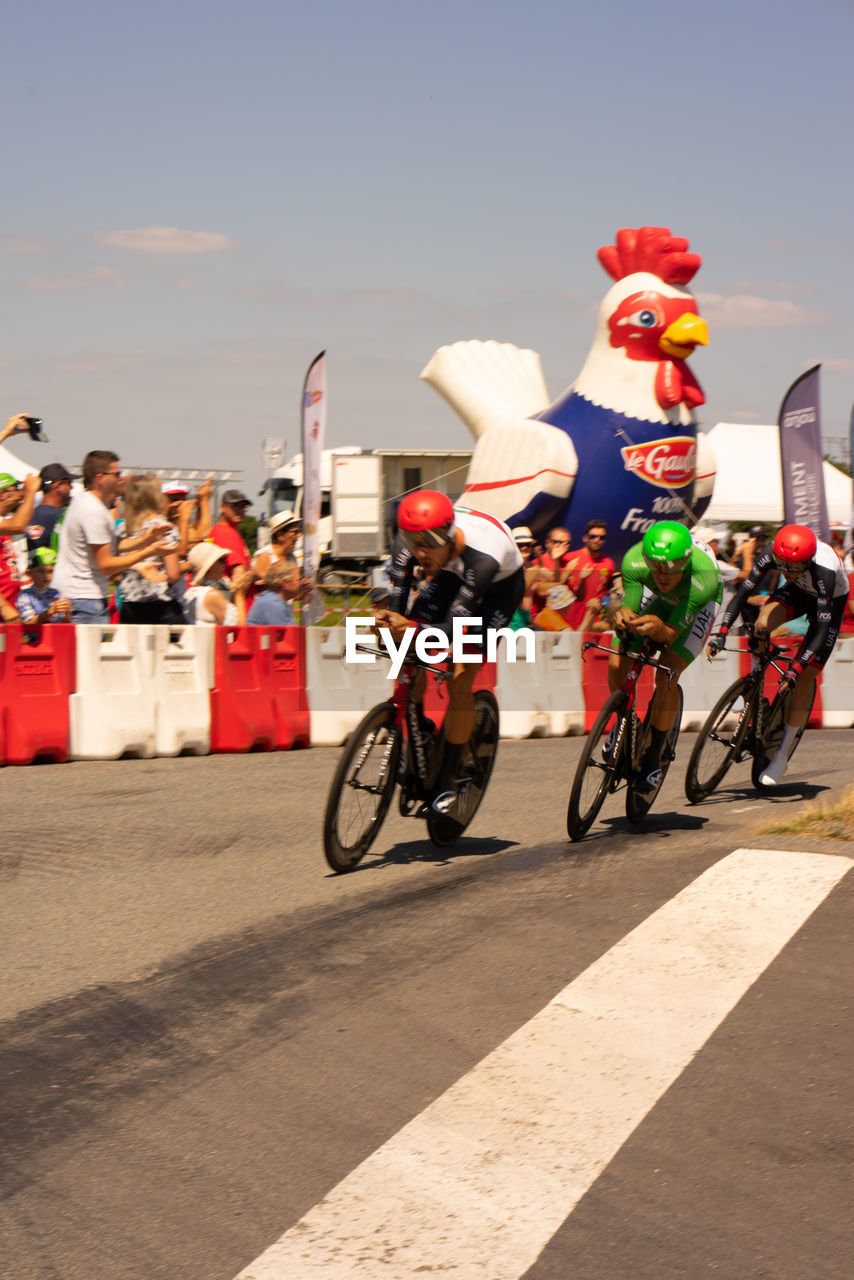 PEOPLE RIDING BICYCLES ON ROAD