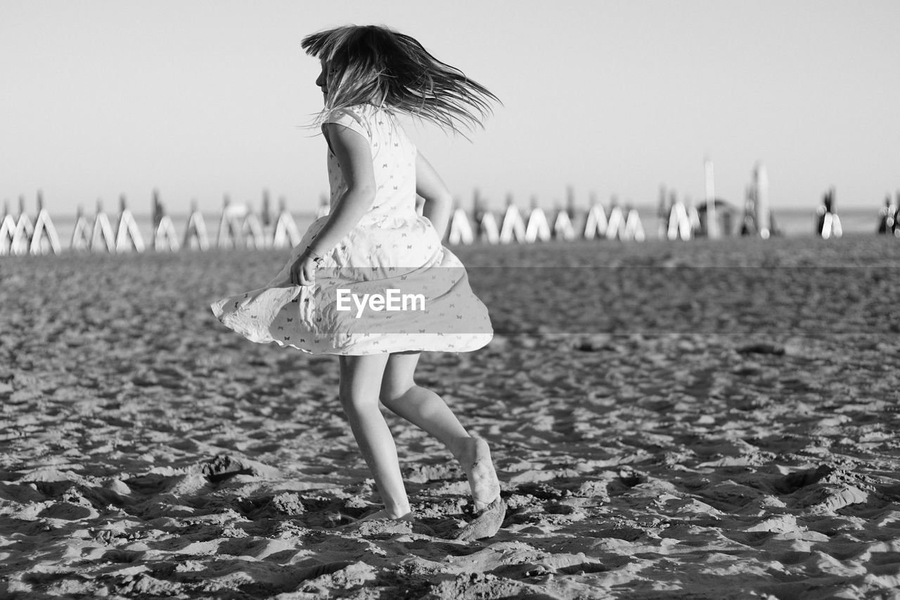 Full length of girl standing on beach