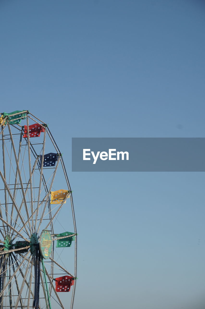 low angle view of ferris wheel against clear sky