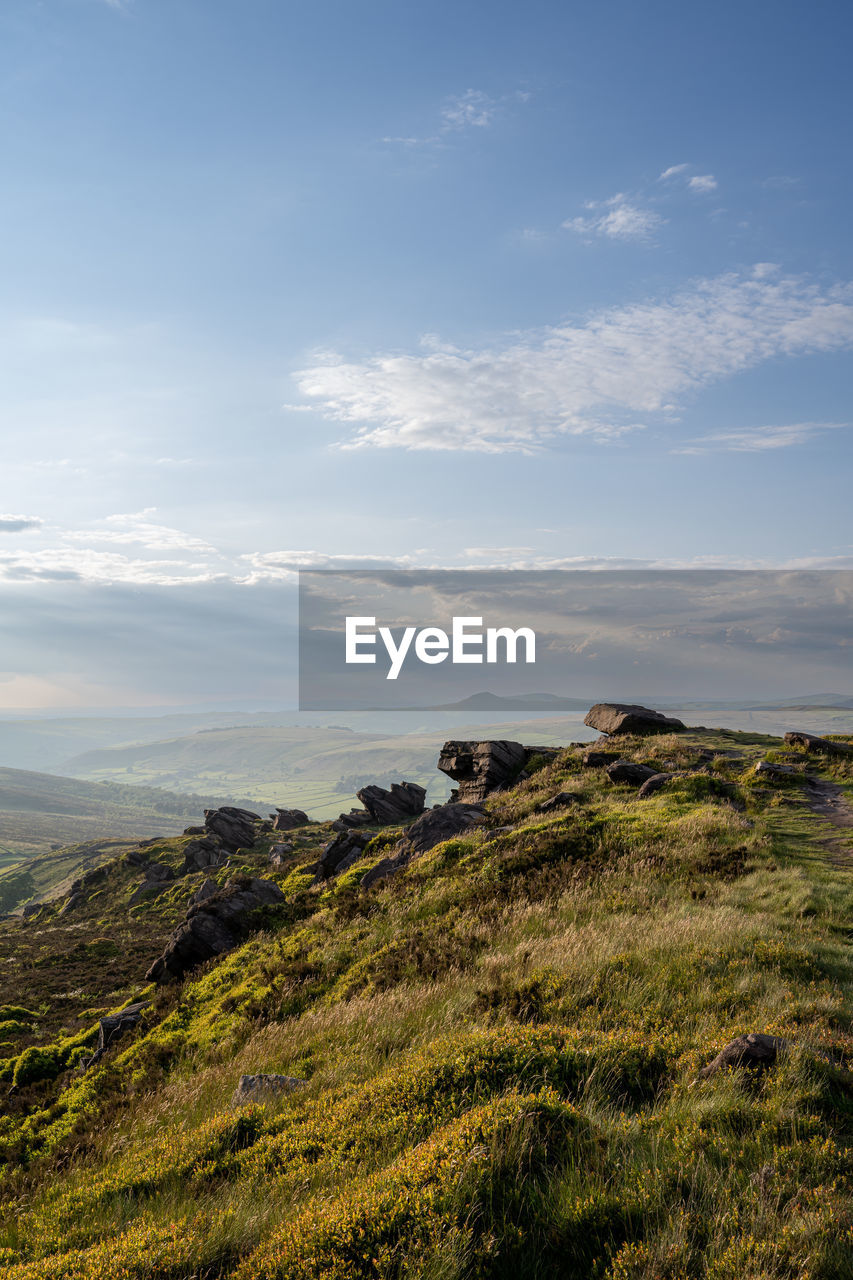 sky, nature, hill, horizon, landscape, scenics - nature, cloud, beauty in nature, environment, coast, rock, sea, land, tranquility, no people, tranquil scene, plant, grass, non-urban scene, wilderness, cliff, natural environment, outdoors, travel destinations, morning, travel, water, day, sunlight, tourism, terrain, idyllic, ridge, reflection