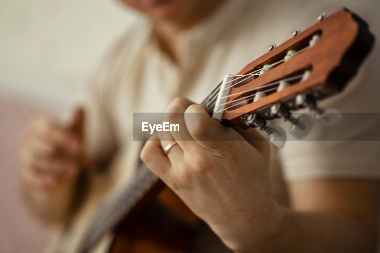 Man playing guitar at home