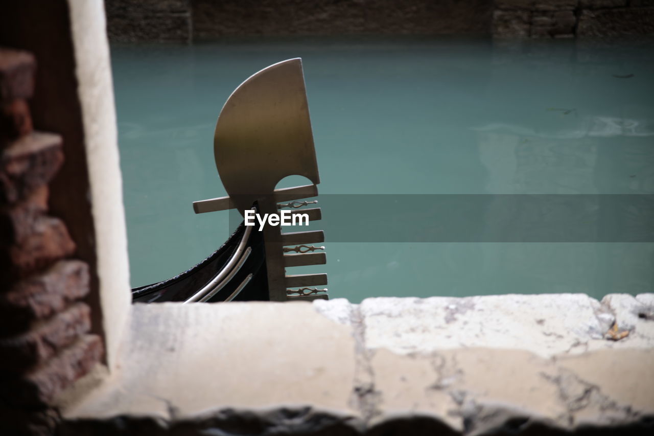 Gondola on canal seen through window