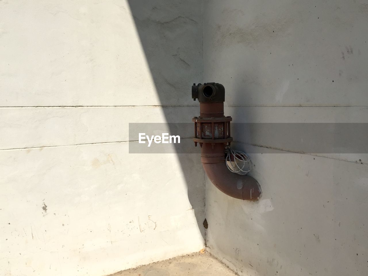 High angle view of pipe on floor against wall