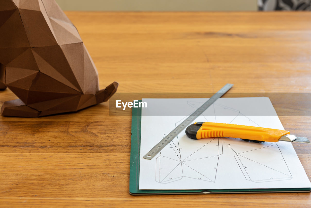 Paper, linear and knife on the table for diy