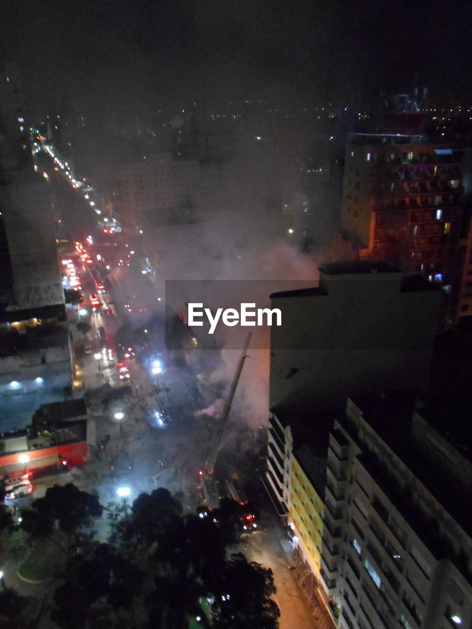 HIGH ANGLE VIEW OF ILLUMINATED BUILDINGS IN CITY