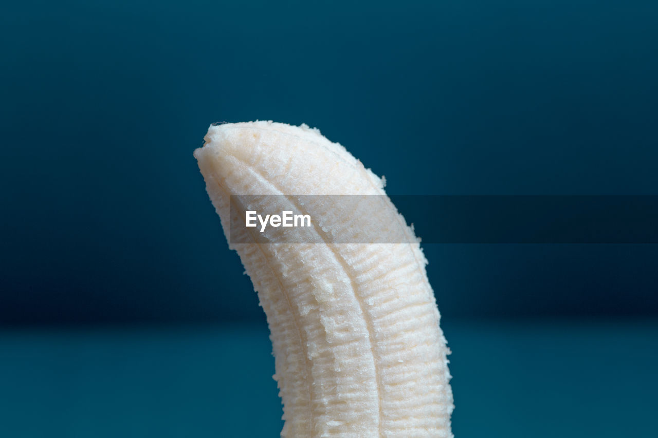 Close-up of banana against blue background