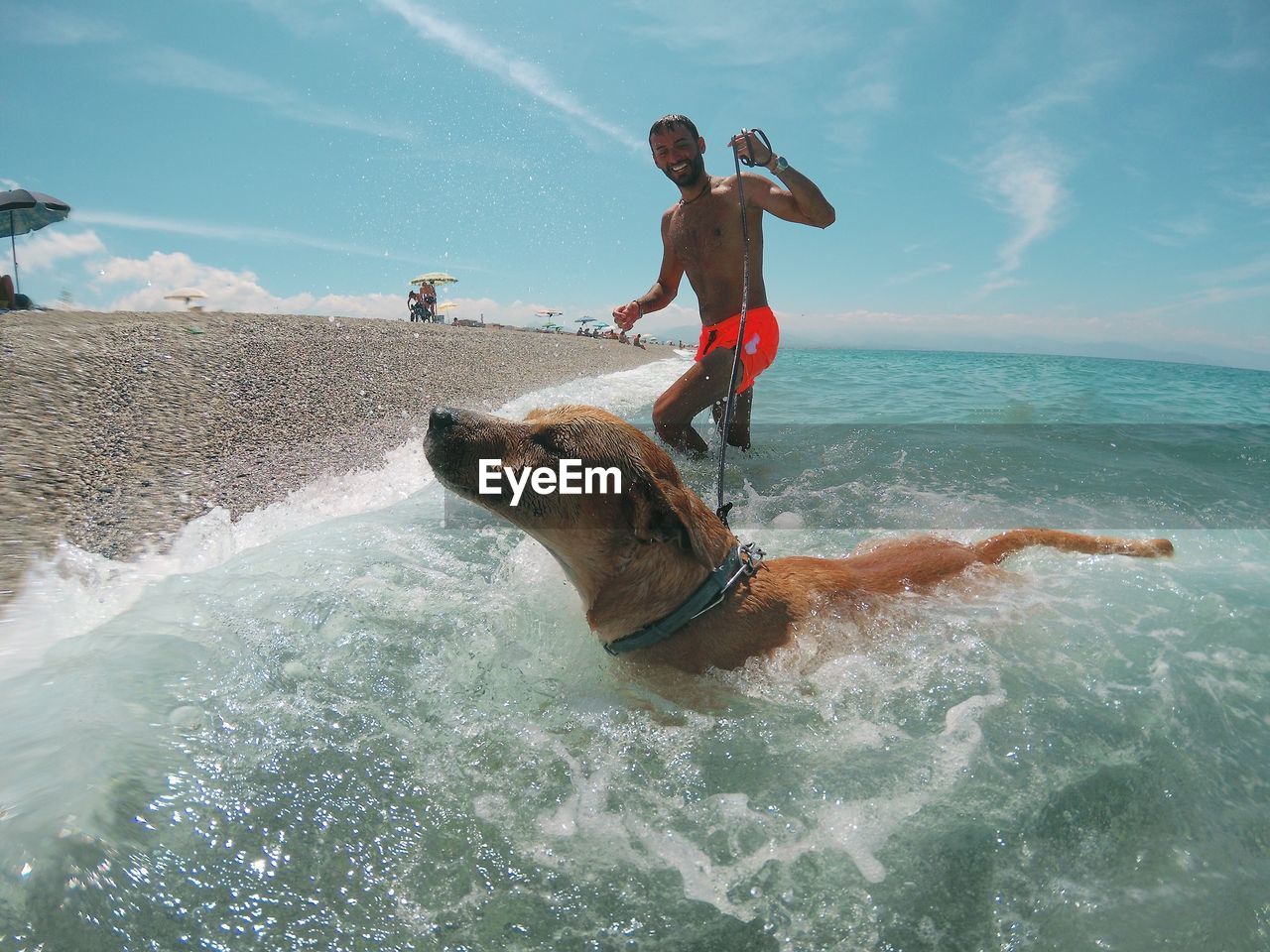 Man surfing on sea against sky