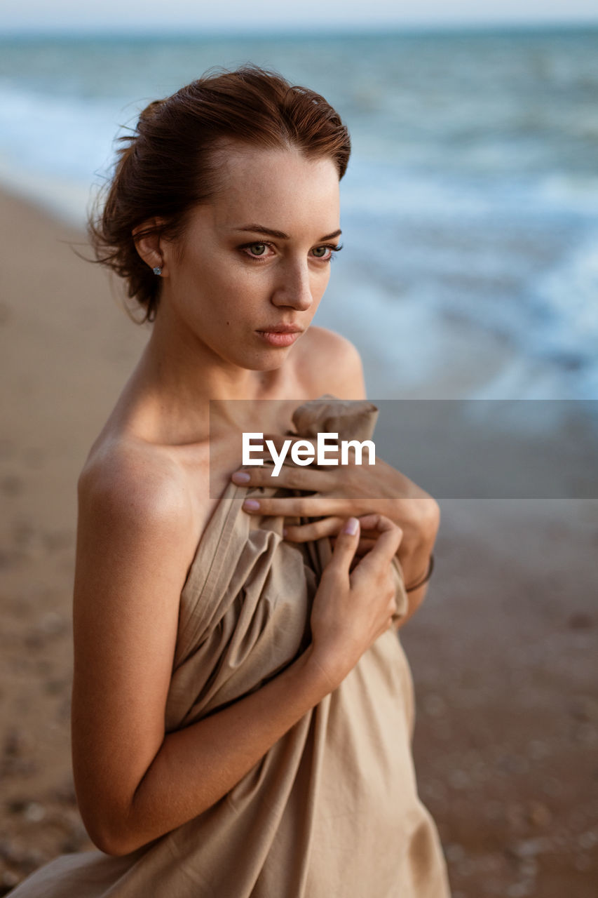 Young woman standing at beach