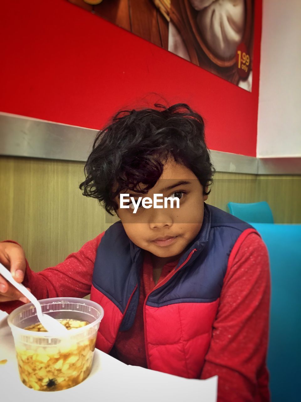 Close-up of boy having food at restaurant