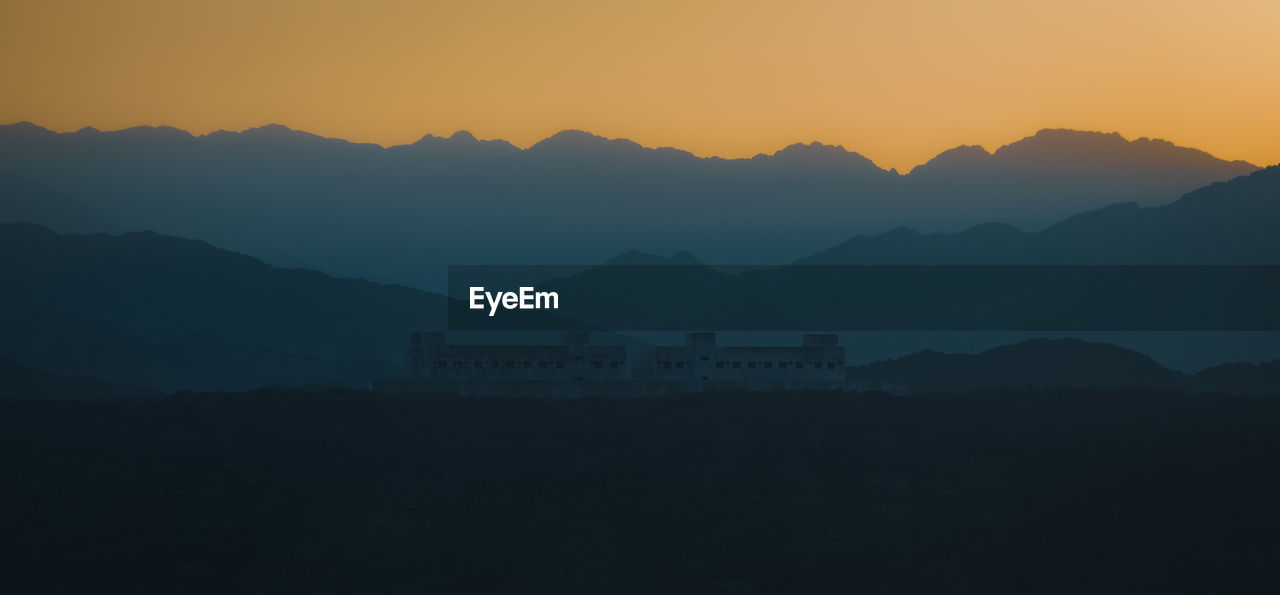 scenic view of silhouette mountain against sky during sunset