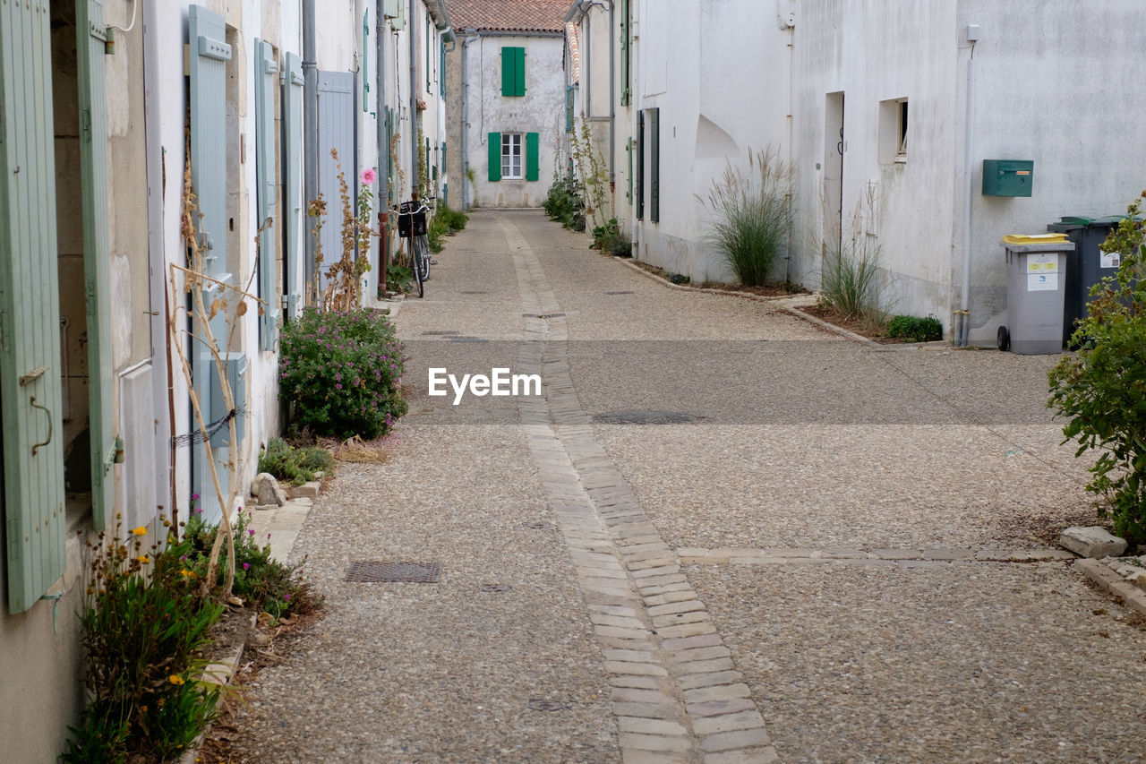 EMPTY ALLEY AMIDST BUILDINGS