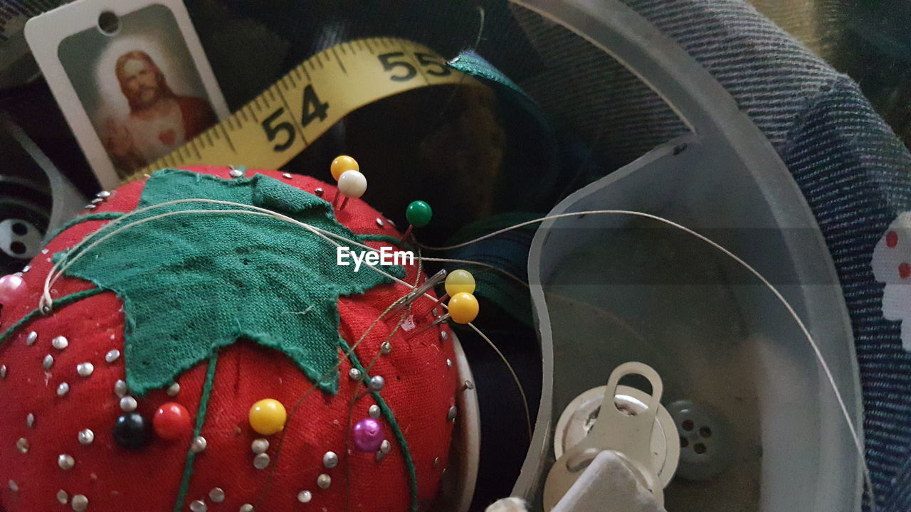 High angle view of various sewing objects in bowl