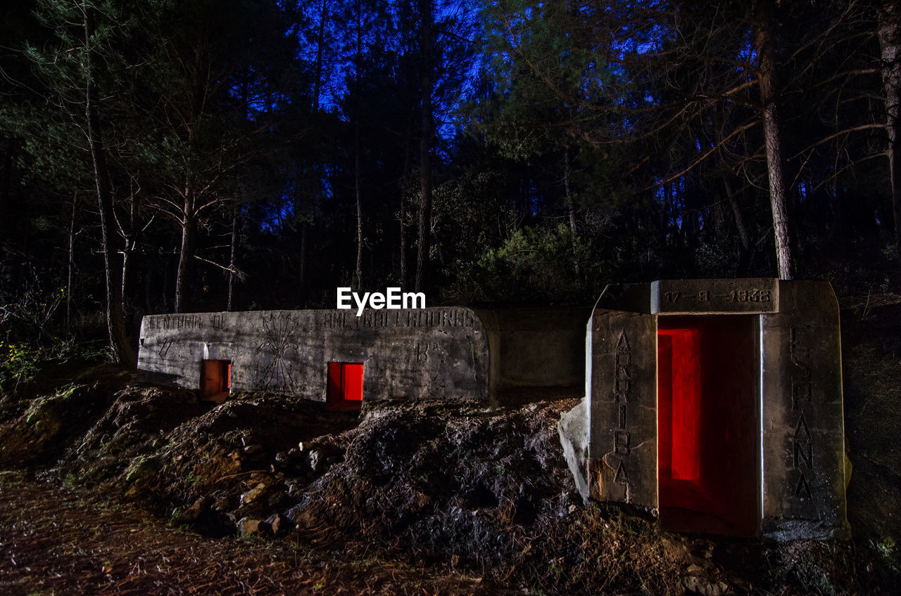 View of a bunker against trees at night