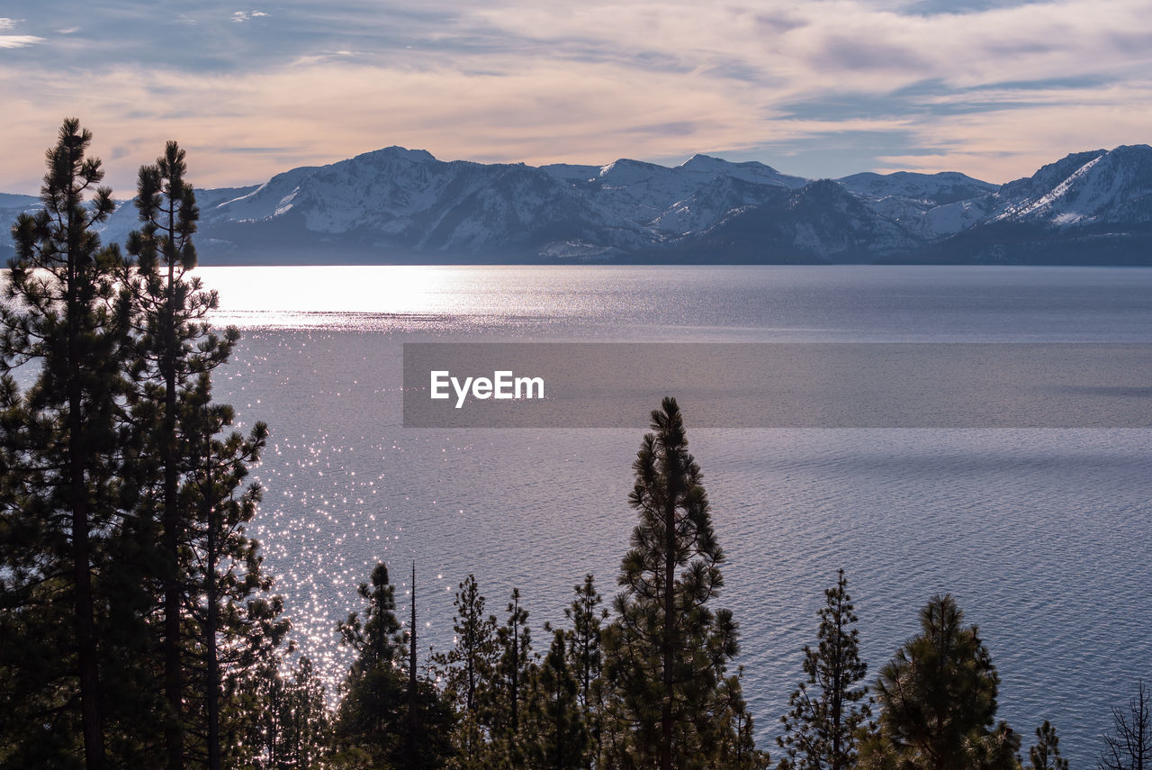 Scenic view of lake and mountains against sky during winter