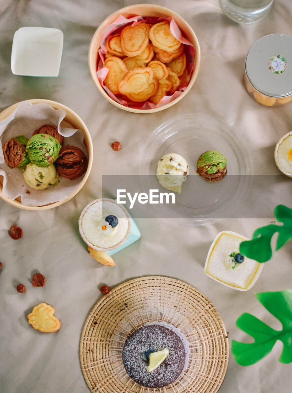 food and drink, food, high angle view, healthy eating, drink, freshness, table, bowl, wellbeing, no people, indoors, refreshment, vegetable, fruit, household equipment, drinking glass, directly above, glass, produce, meal, sweet food, crockery, plate