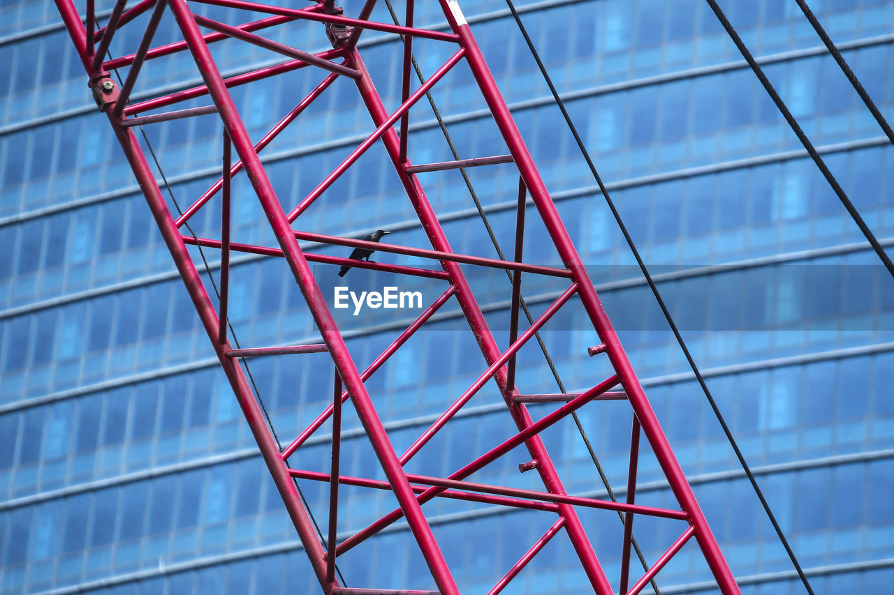 Low angle view of grid structure against blue sky