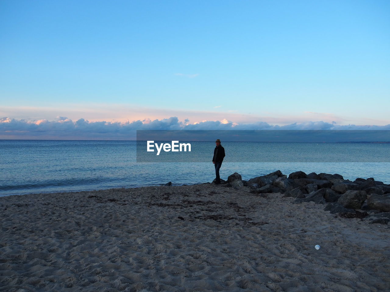 Man standing on beach against sky