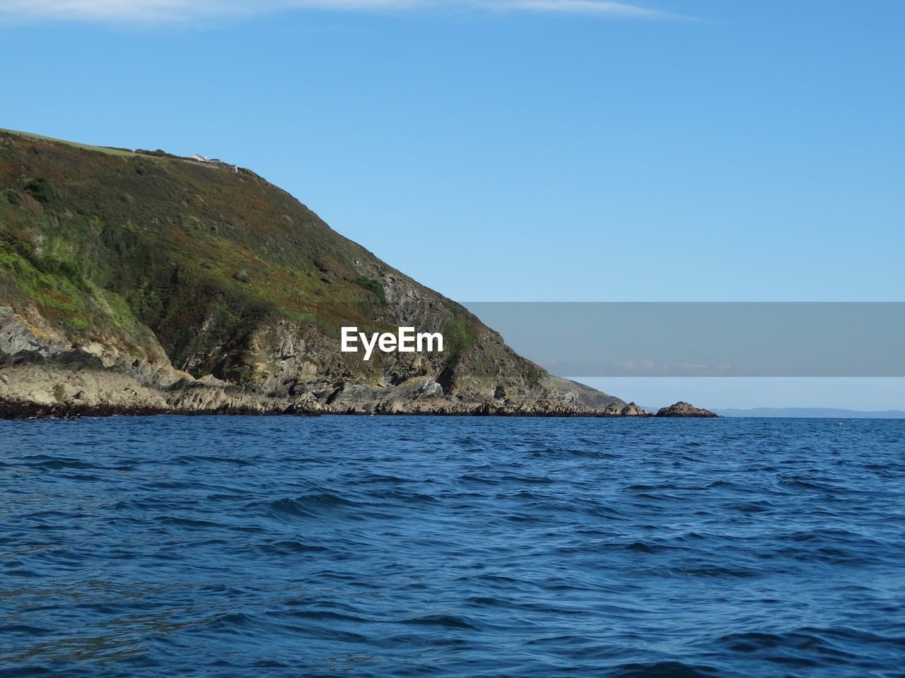 Scenic view of calm sea against clear sky