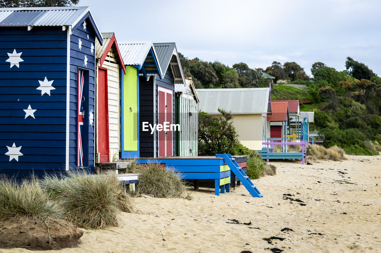 HOUSES ON BEACH AGAINST BUILDINGS