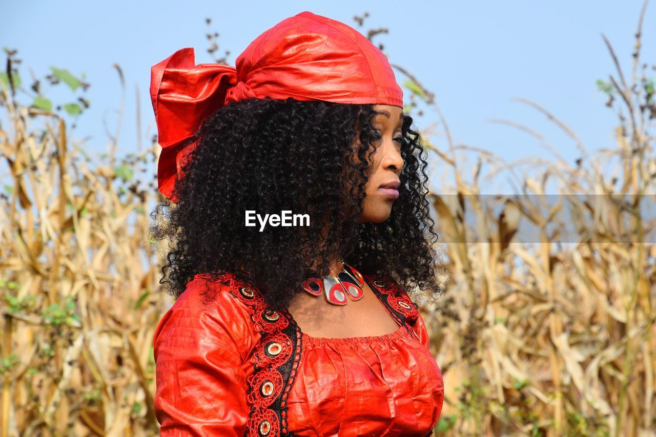 Woman with curly hair standing on field