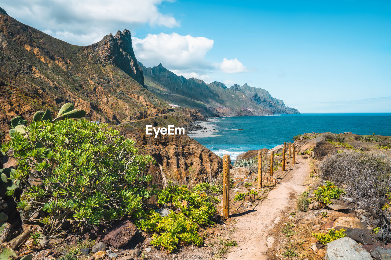 scenic view of sea and mountain against sky