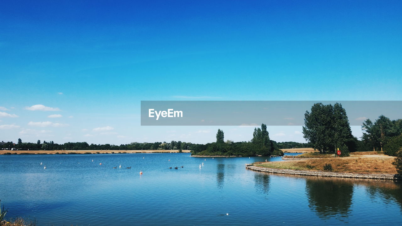 VIEW OF LAKE AGAINST BLUE SKY