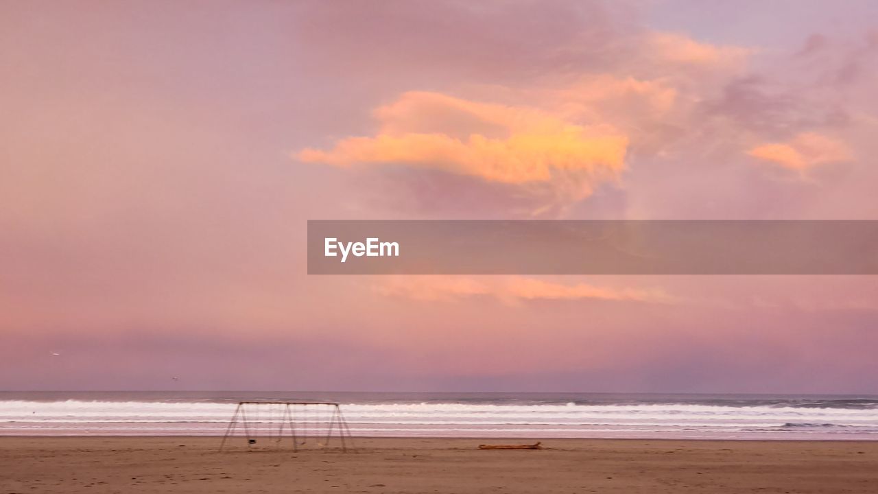 SCENIC VIEW OF BEACH DURING SUNSET