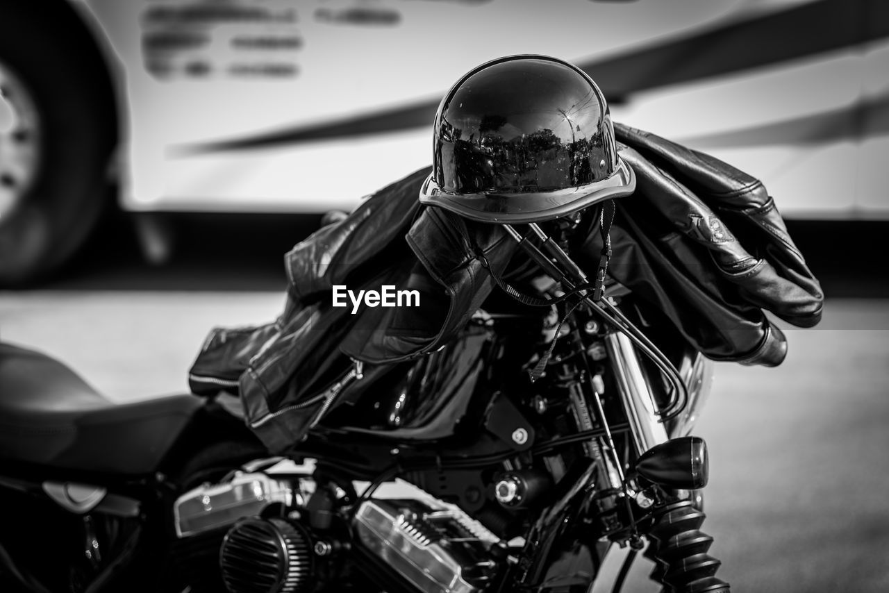 Helmet and leather jacket on motorcycle at street