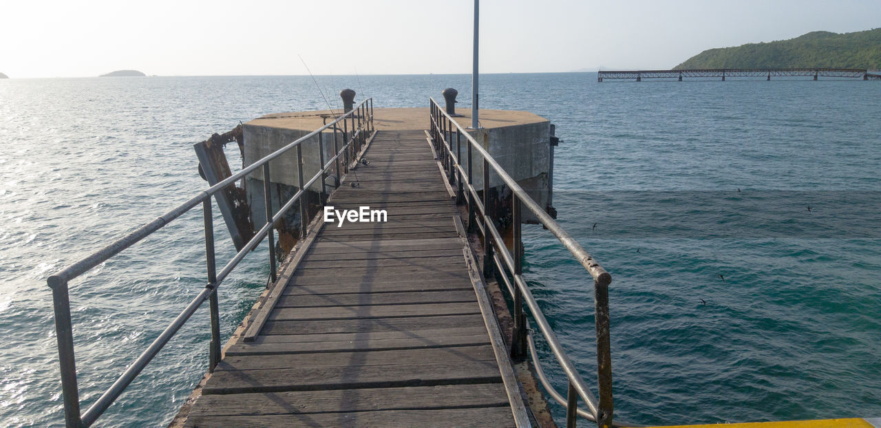 PIER AMIDST SEA AGAINST SKY