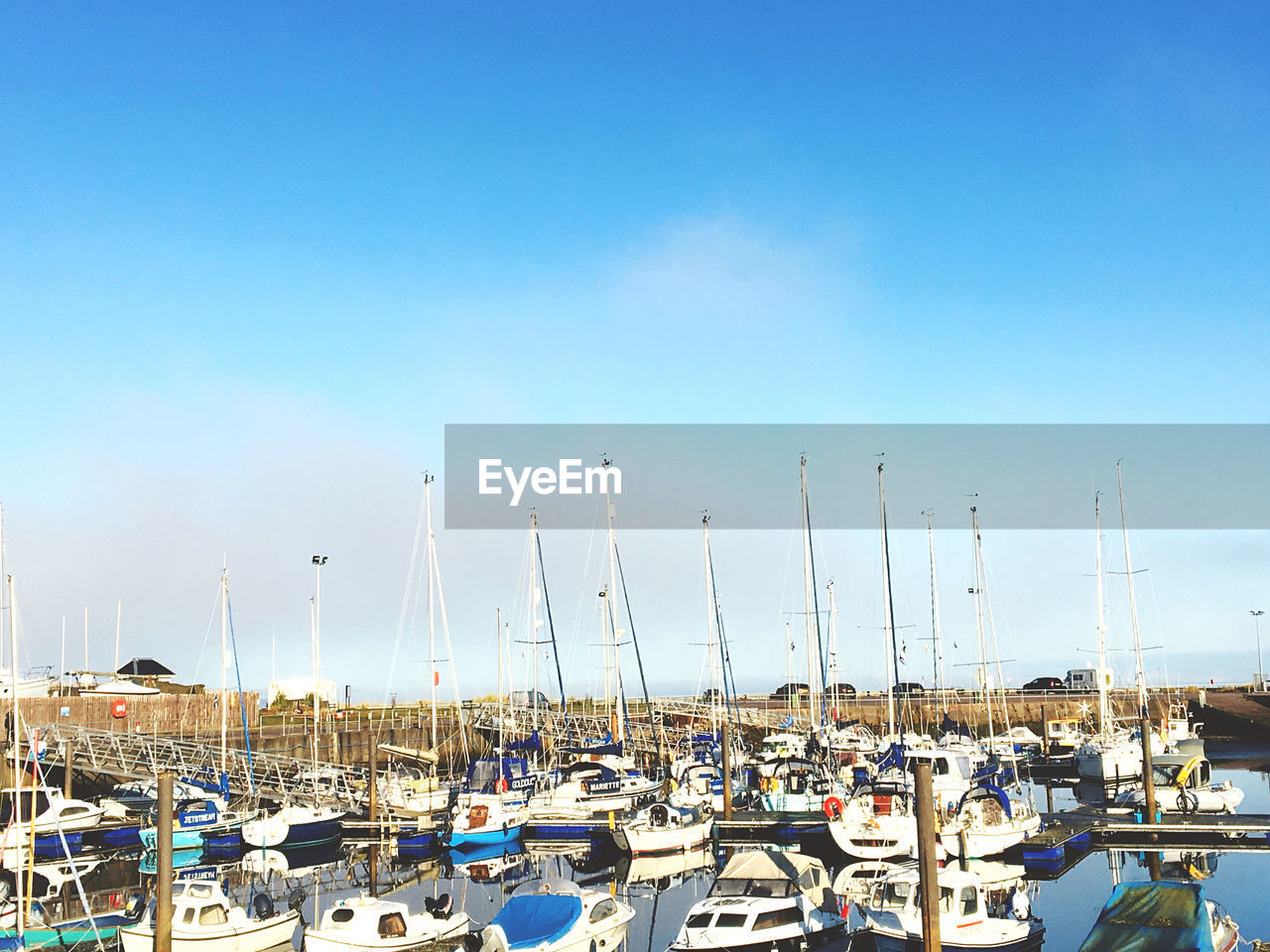 BOATS MOORED IN HARBOR