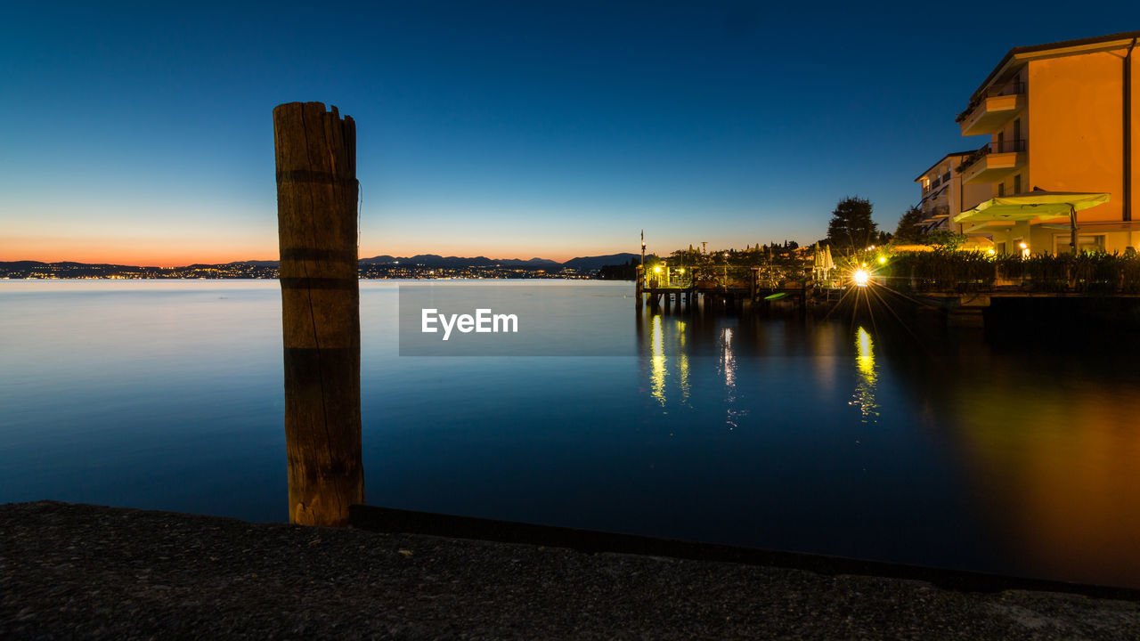 Scenic view of lake against sky at sunset