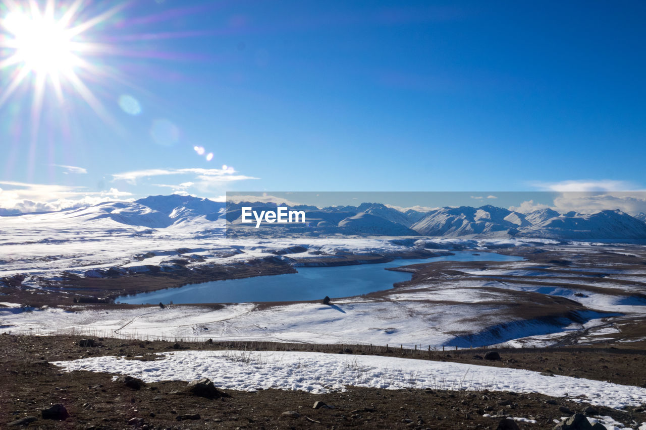 Scenic view of frozen lake against sky