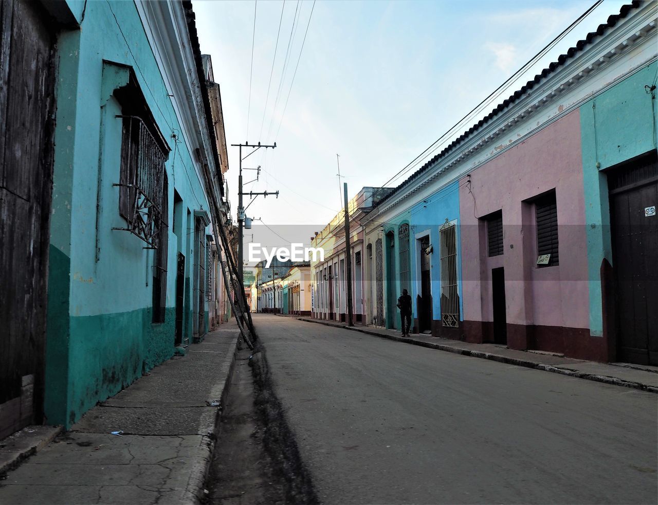 STREET AMIDST BUILDINGS AGAINST SKY