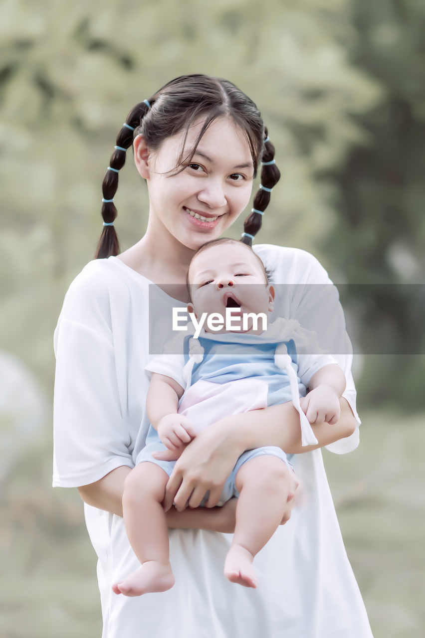 Portrait of mother with son outdoors