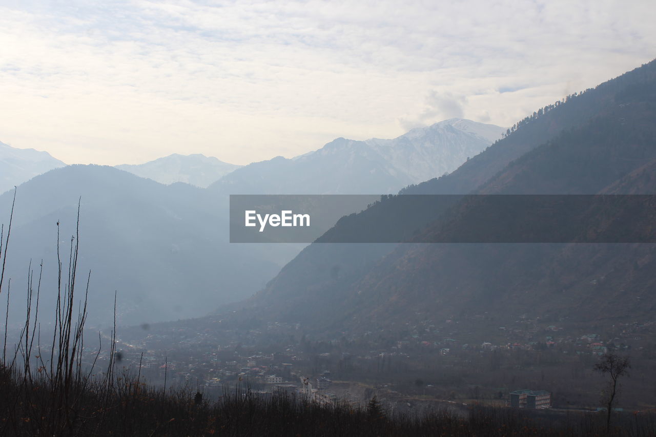mountain, environment, scenics - nature, landscape, beauty in nature, mountain range, nature, land, sky, fog, plant, morning, tree, no people, tranquility, tranquil scene, valley, forest, cloud, outdoors, travel, ridge, wilderness, travel destinations, cold temperature, winter, non-urban scene, tourism, snow, pinaceae, grass, mist, coniferous tree, day, social issues, pine tree