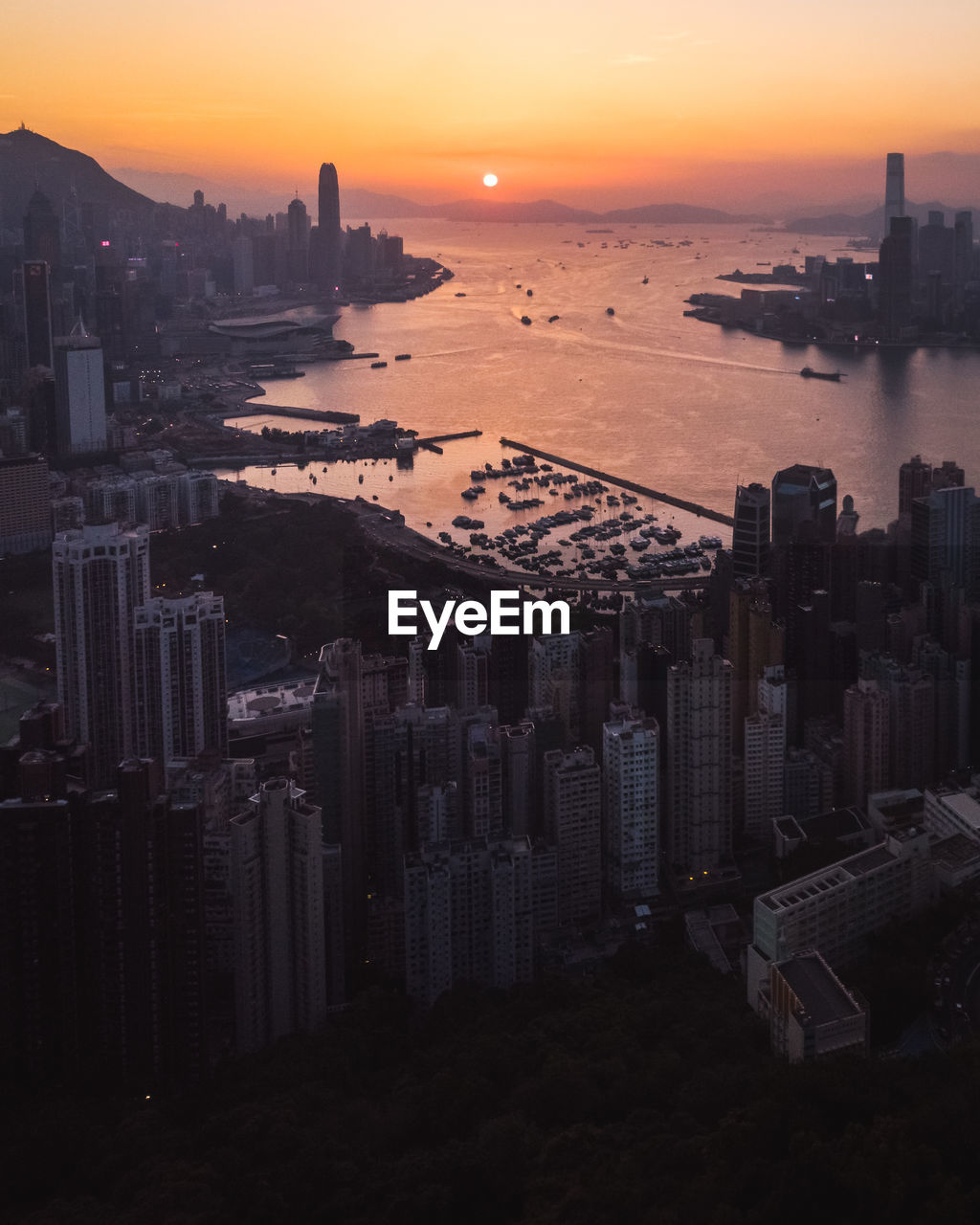 High angle view of buildings in city during sunset