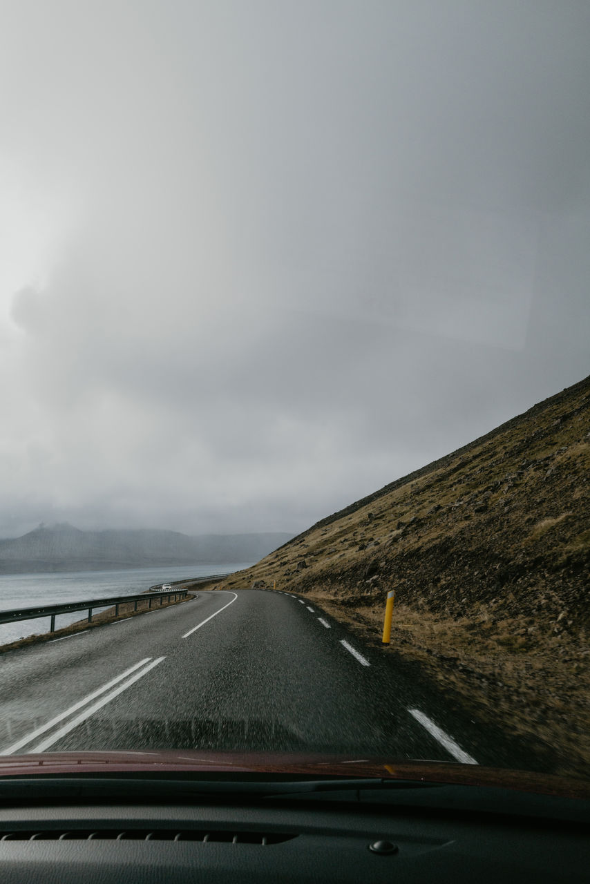 View from the car on the road leading towards mountains in iceland