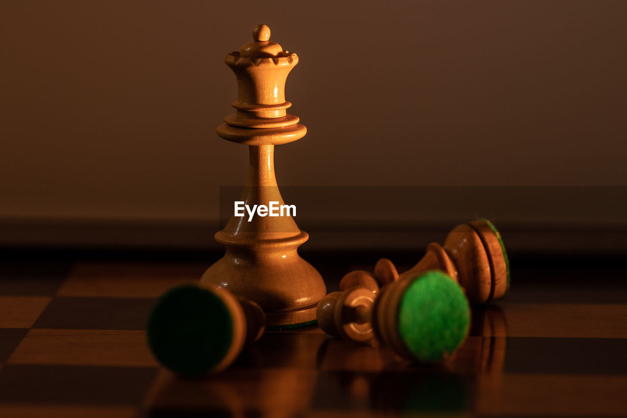 CLOSE-UP OF CHESS PIECES ON THE FLOOR