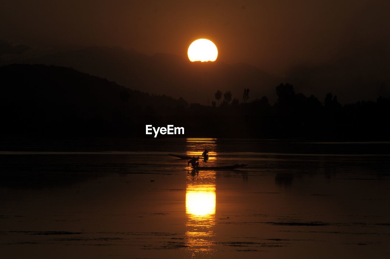 SCENIC VIEW OF LAKE AGAINST ORANGE SKY