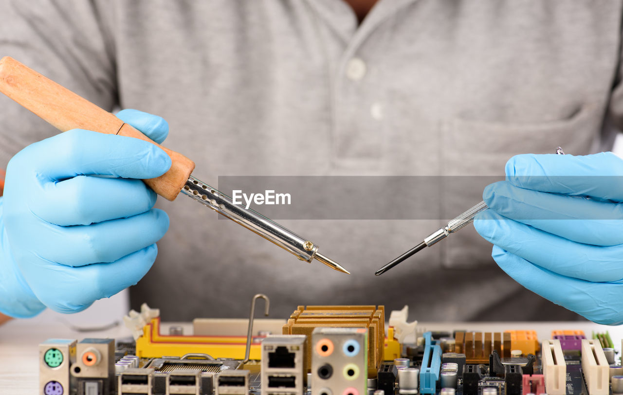 Close-up of engineer repairing circuit board