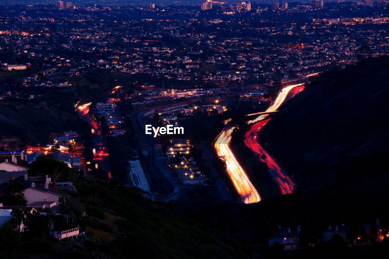 HIGH ANGLE VIEW OF ILLUMINATED CITY AT NIGHT
