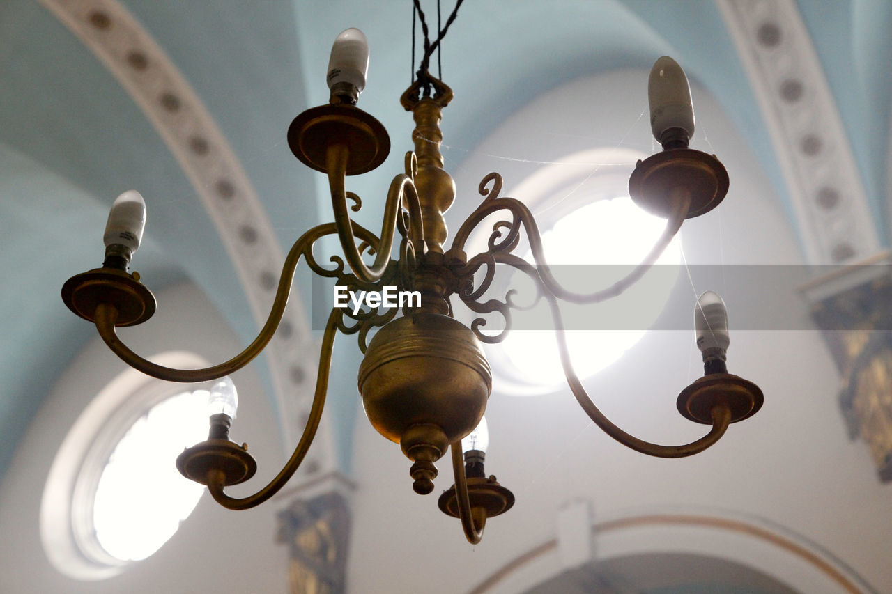 Low angle view of chandelier in brightly lit church