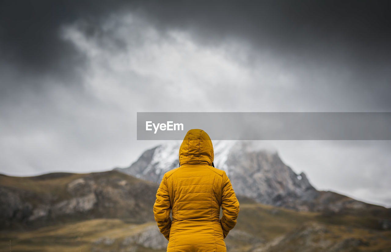 Rear view of person against mountain and sky