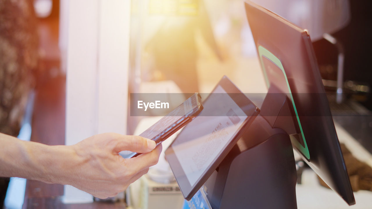 midsection of woman using digital tablet at office