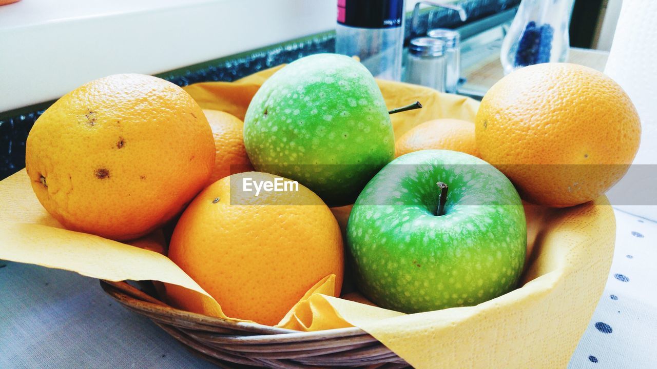 Close-up of fruits in basket on table