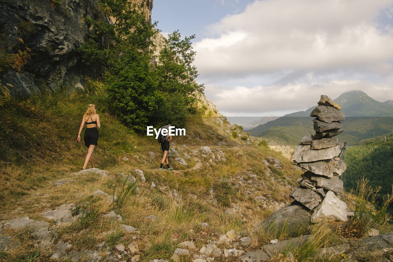 Rear view of man walking on mountain