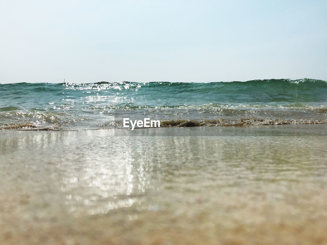 SURFACE LEVEL OF SEA AGAINST CLEAR SKY