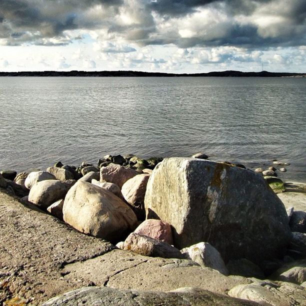 SCENIC VIEW OF SEA WITH ROCKS IN BACKGROUND