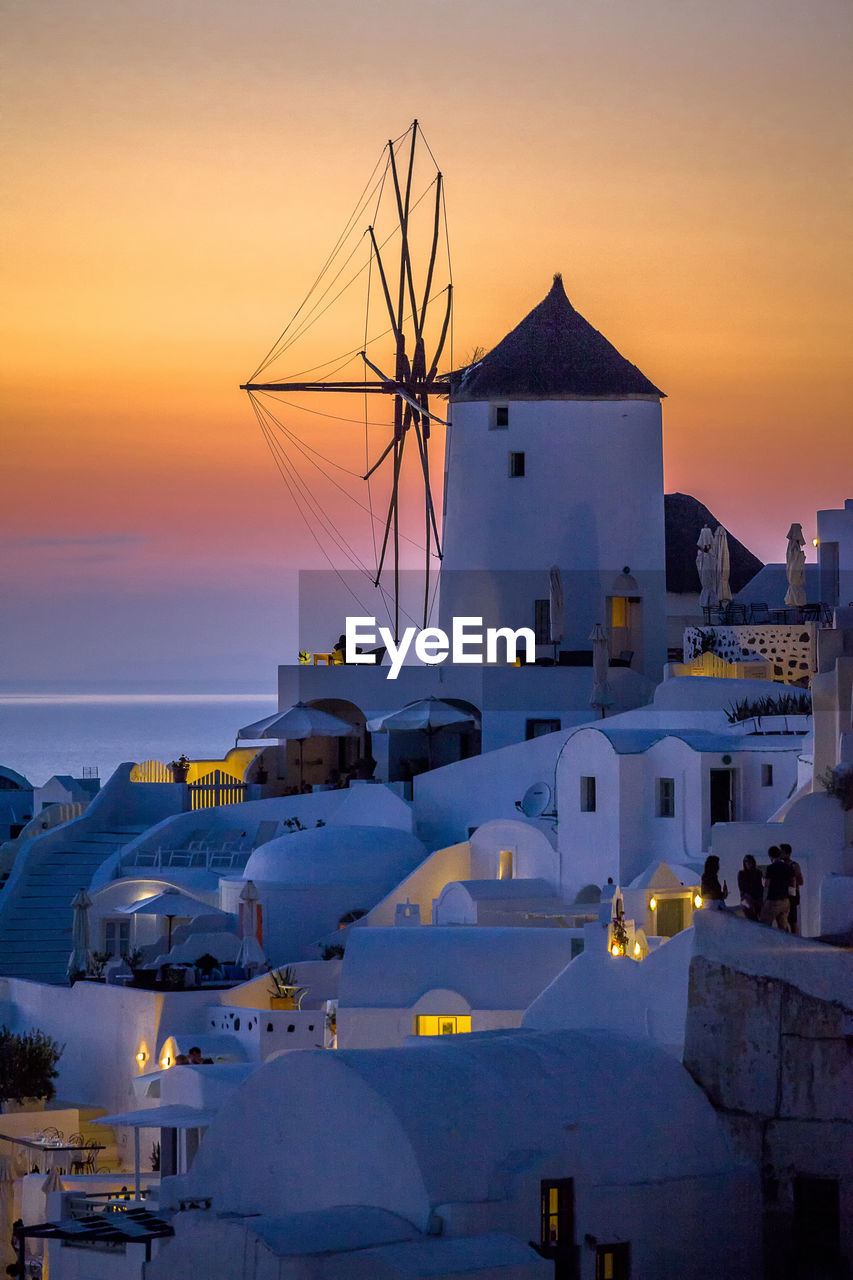 Houses by sea during sunset at santorini