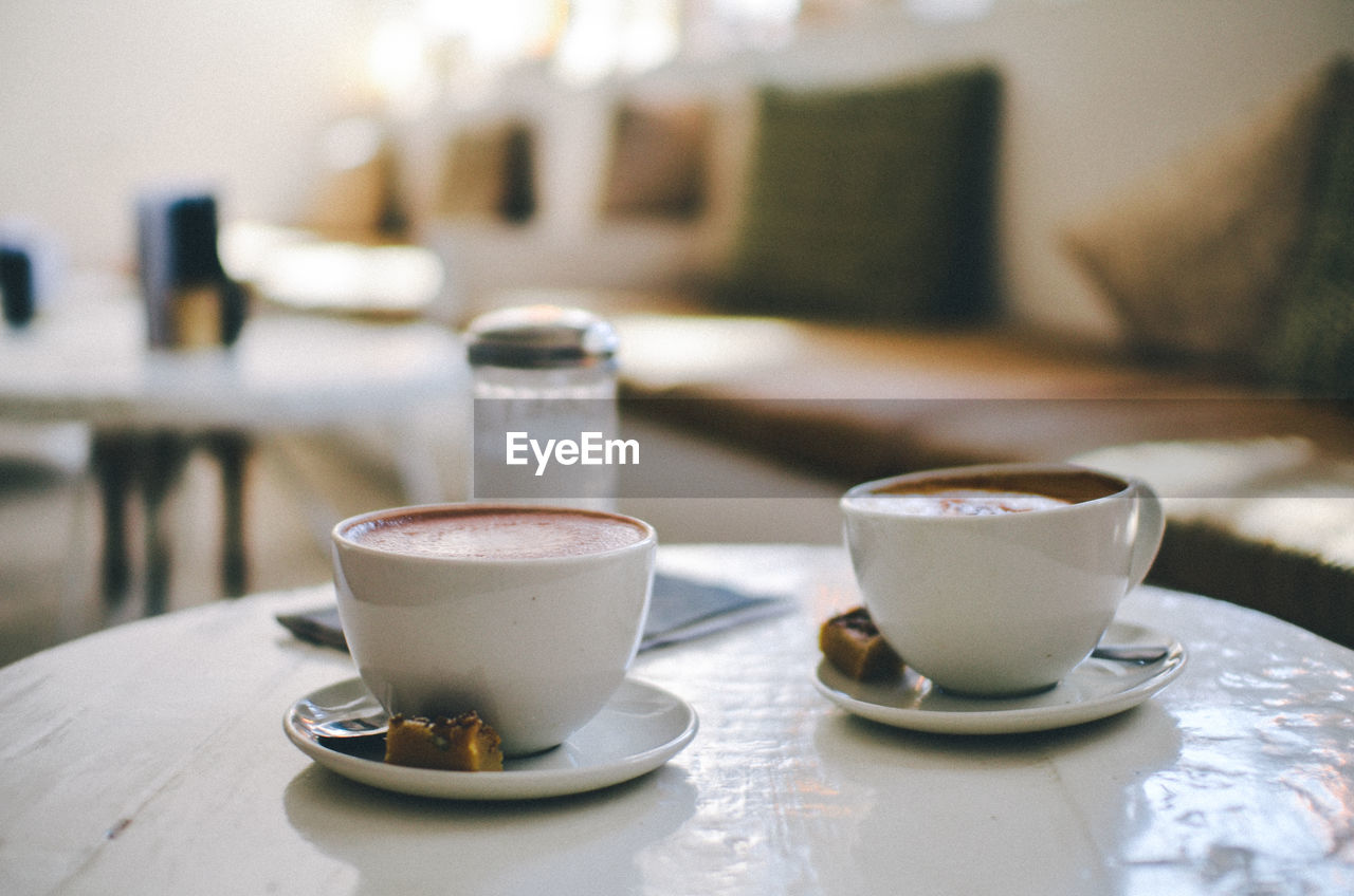 Close-up of coffees served on table